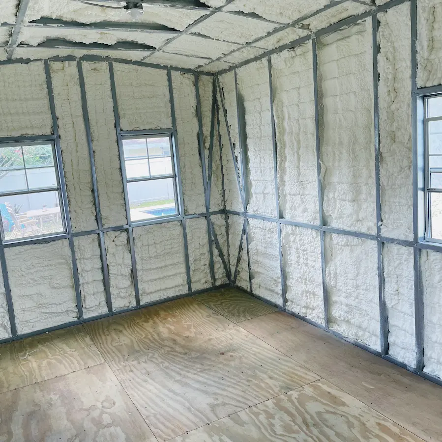 Closed-cell spray foam insulation applied to wall cavities in a residential project in Hamlet